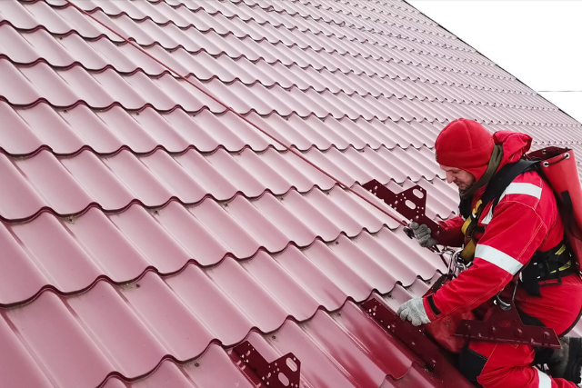 Worker Does the Installation of the Roof of House